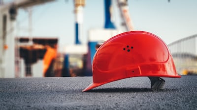 Construction site where wearable tags trigger alerts as workers approach heavy-equipment safety zones